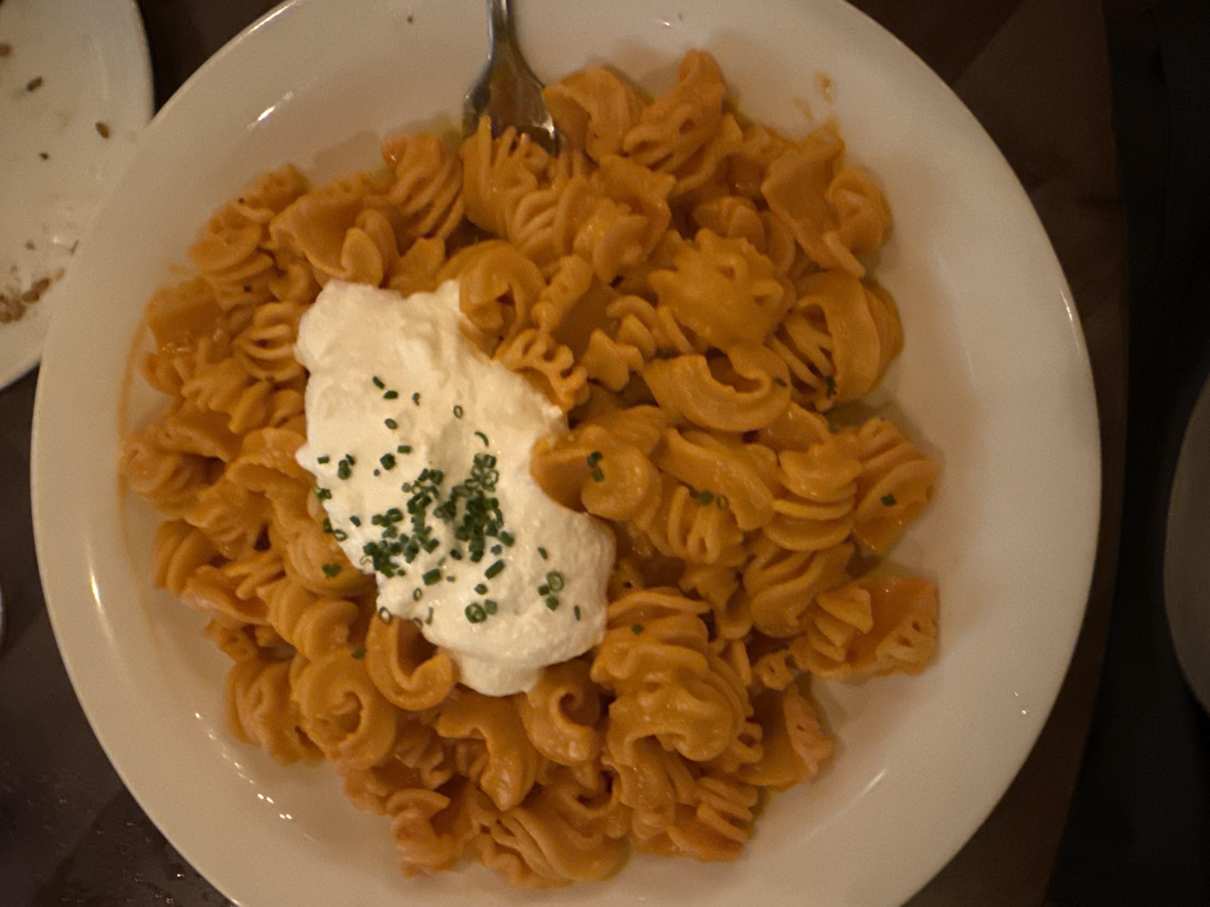 A plate of pasta with burrata